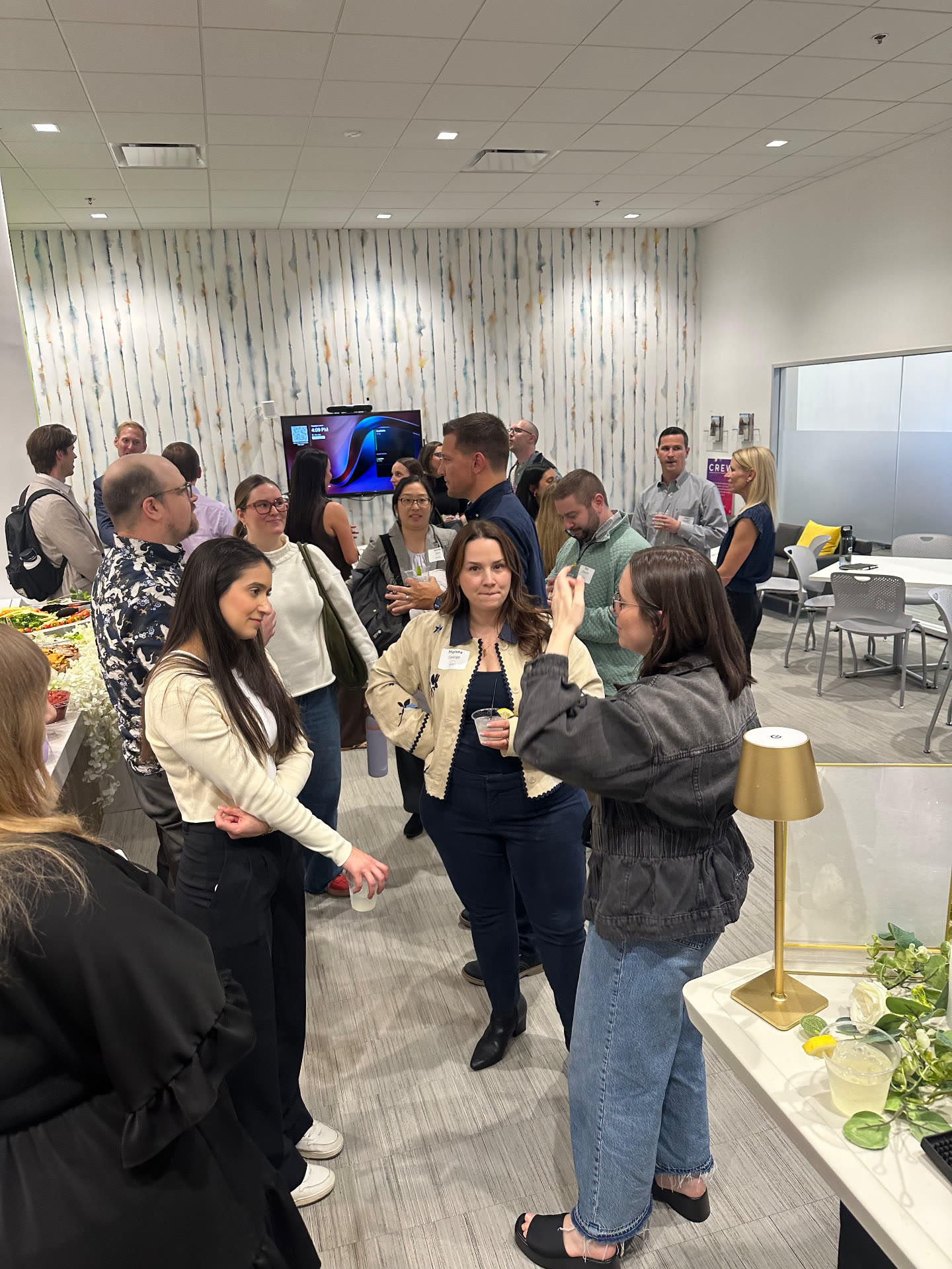 Guests networking with cocktails during a Raven's Reserve corporate hospitality event