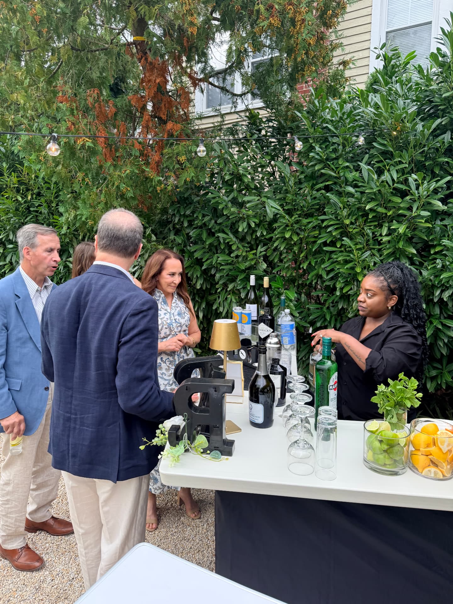 Raven's Reserve bartender serving guests at the bar during a wedding rehearsal dinner